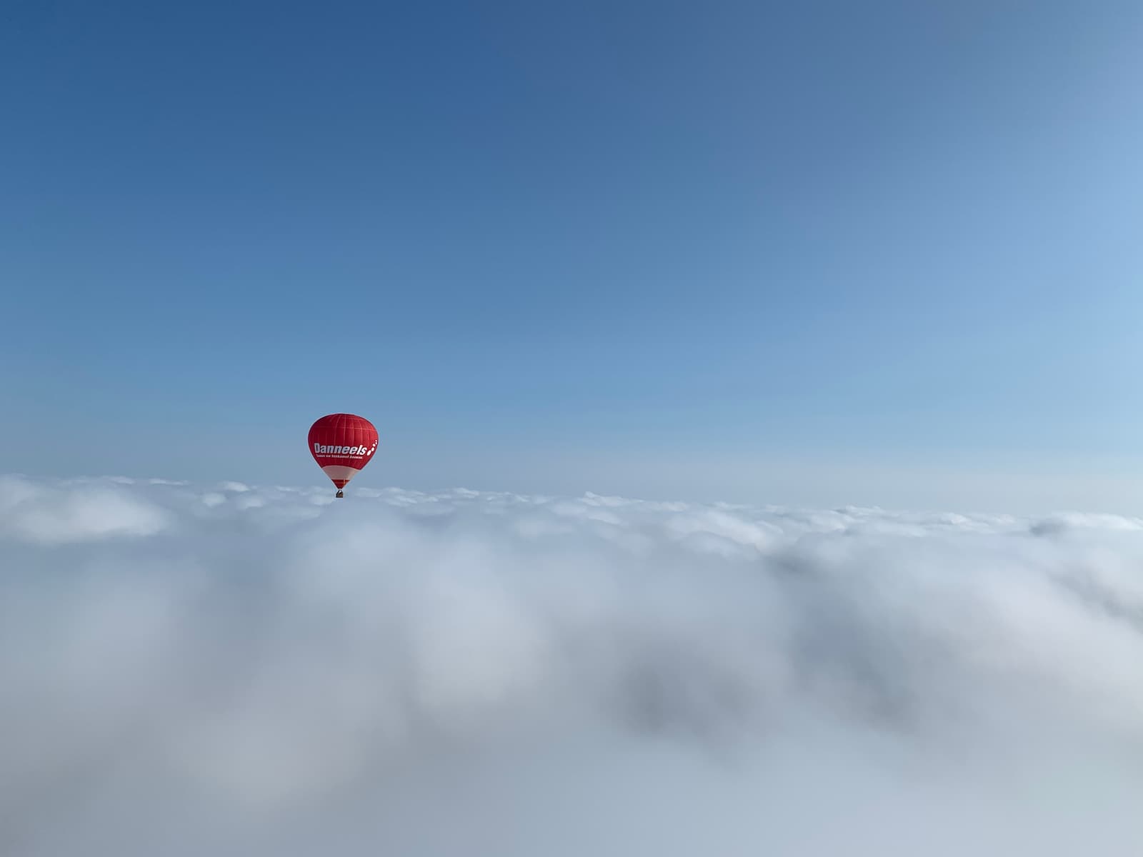 Hot Air Balloon flying over the clouds